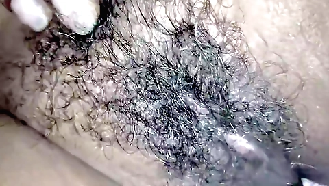 Indian woman with hairy pussy gets a lot of fun on the bed