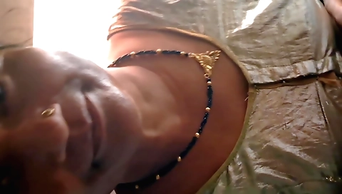 Indian brunette is riding a bike in the train toilet