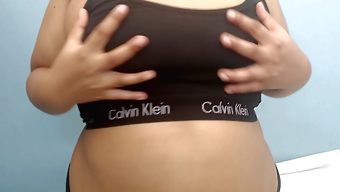 Amateur blonde in a black bikini shows off her boobs